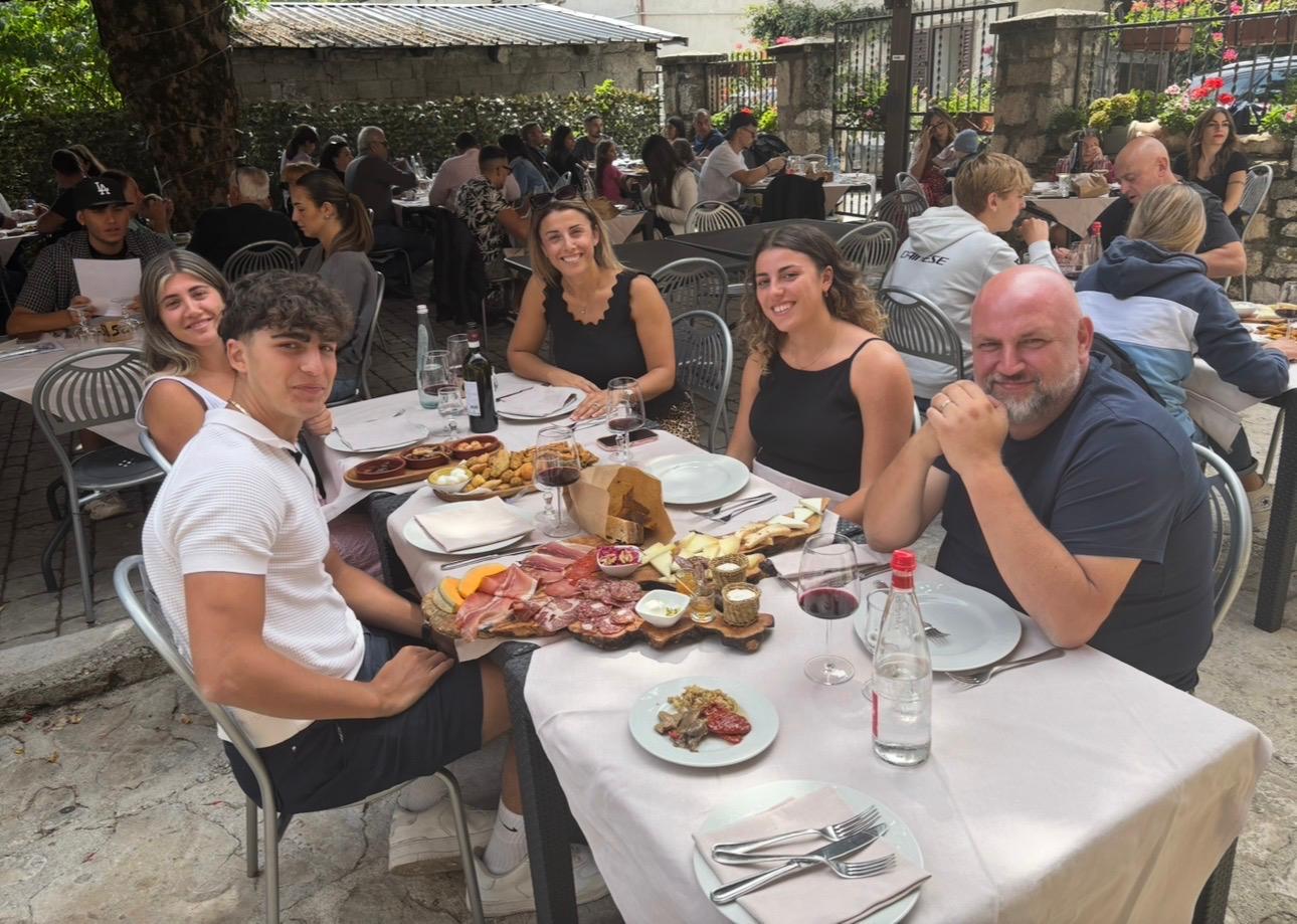 The family behind Toscano enjoying Italian food in Italy