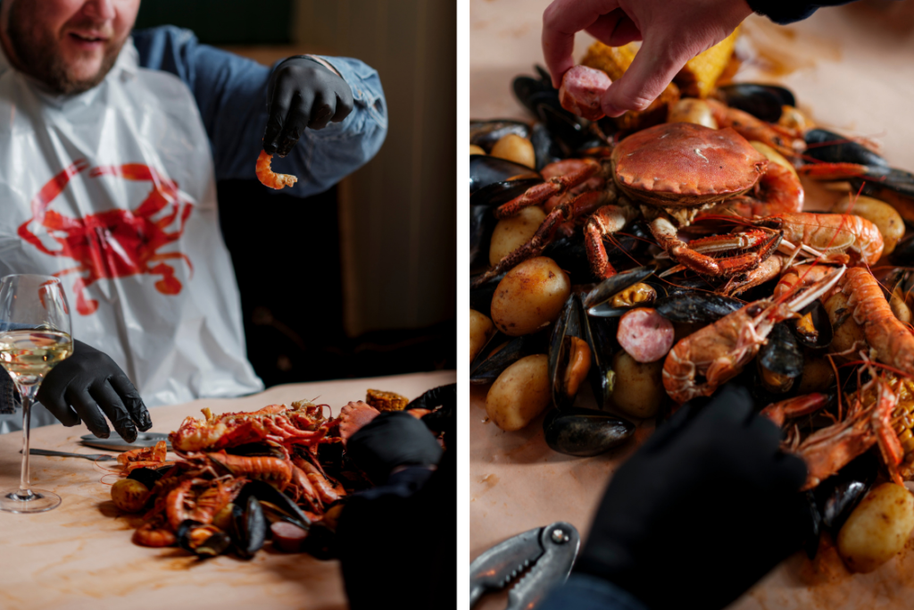 Diner wearing a lobster bib and gloves enjoying a Scottish seafood boil with prawns, mussels and crab at Dulse Leith, Edinburgh